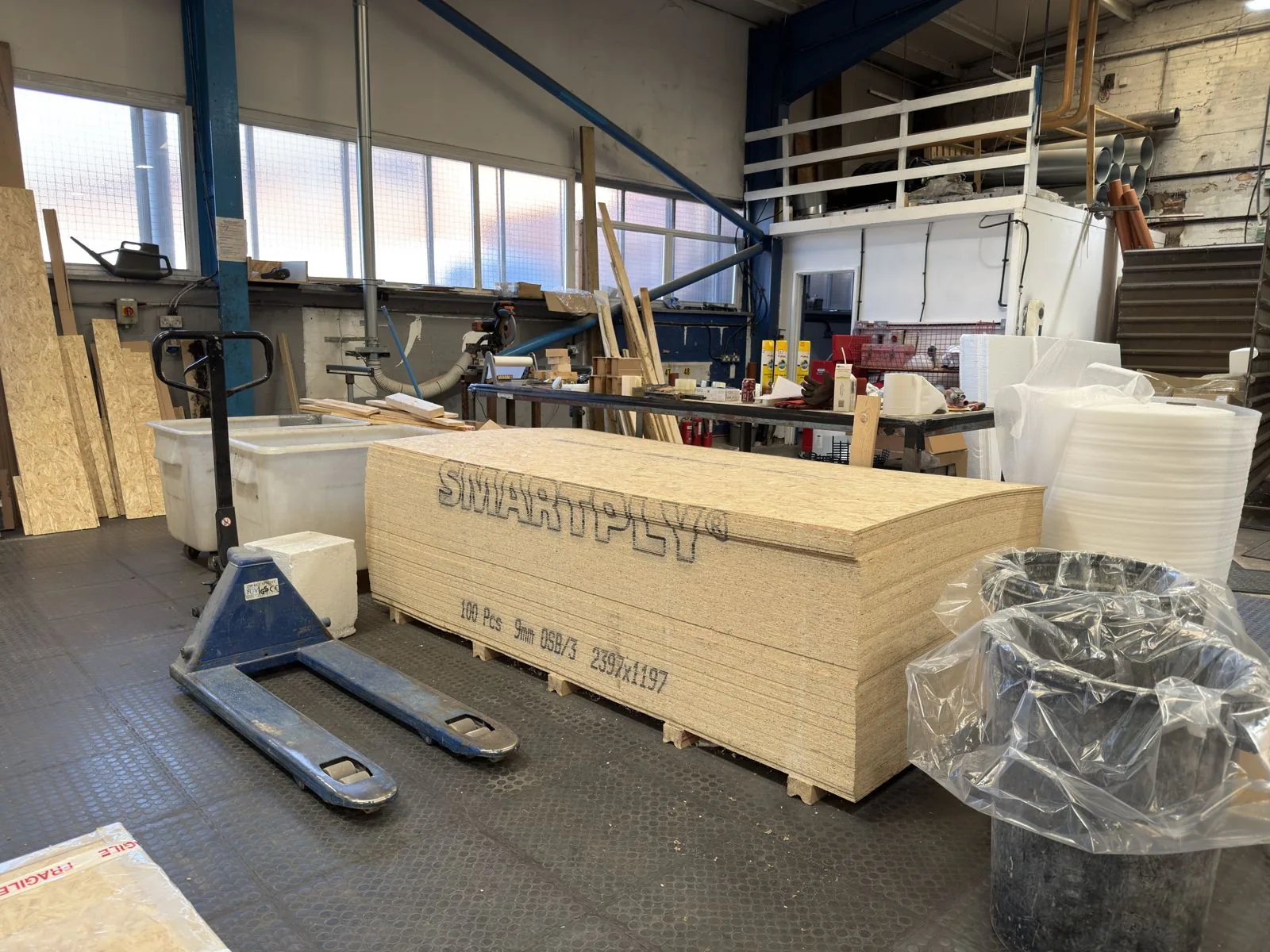 A stack of OSB sheet for export crates in the Simmons works