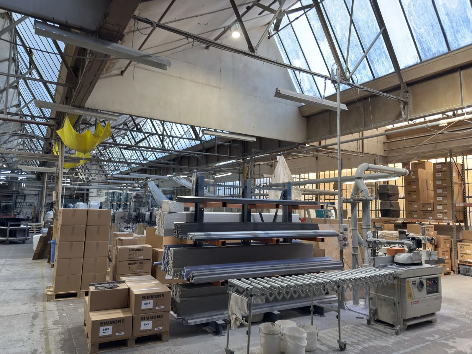 Lengths of cast epoxy resin edging in several colours, racked in the Simmons works