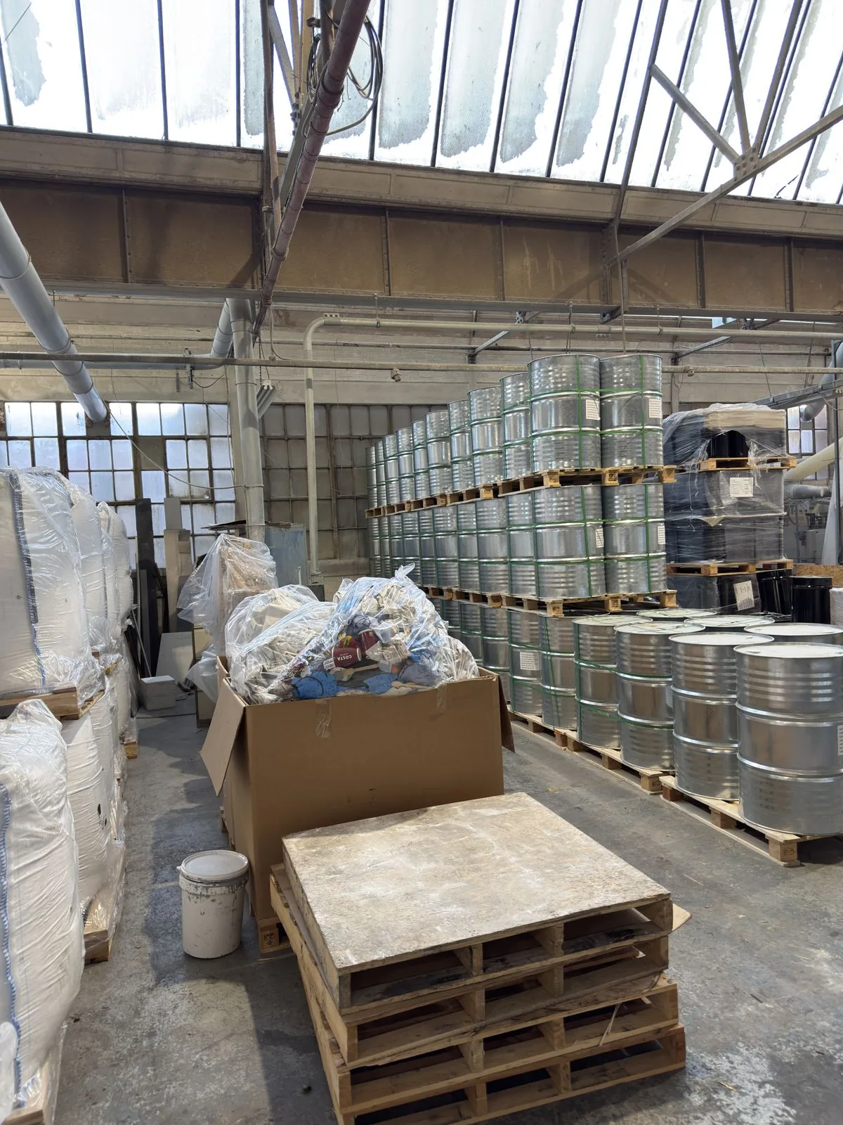 Drums and bulk bags of raw material in the Simmons works